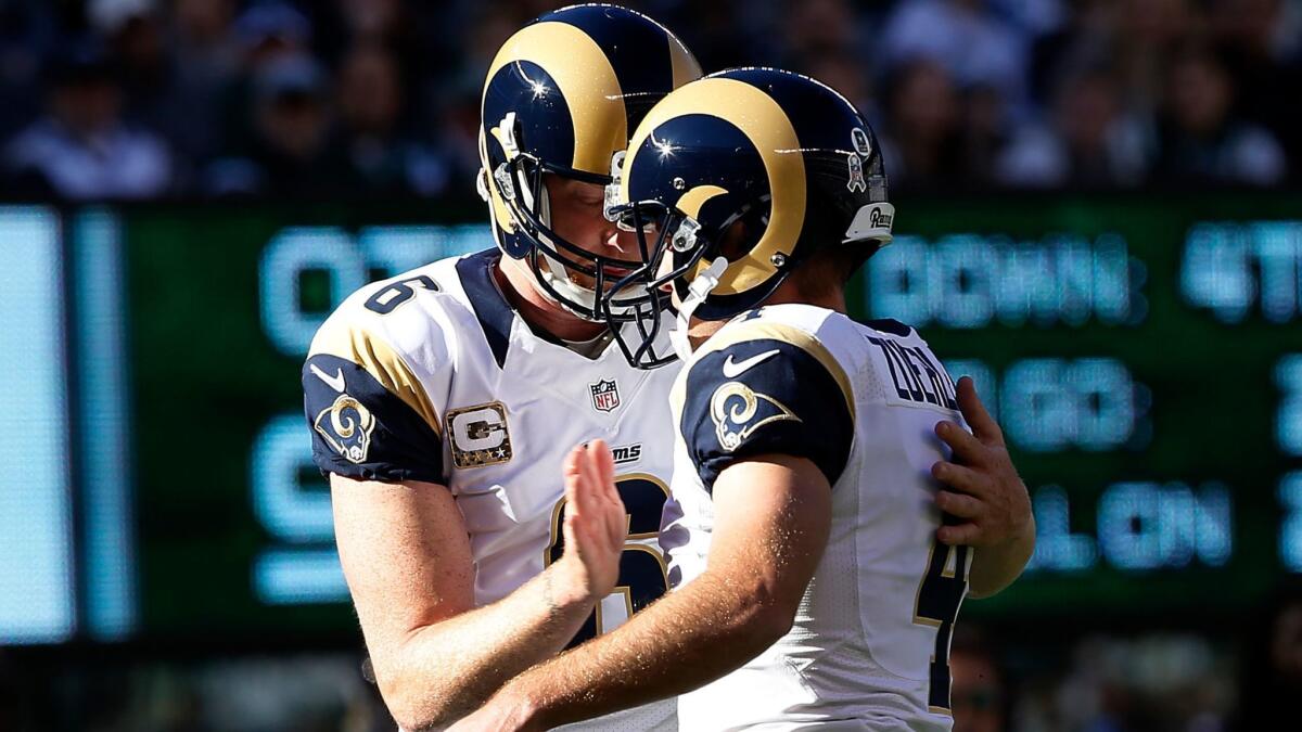 Punter and holder Johnny Hekker (6) congratulates kicker Greg Zuerlein after he scored the Rams' first points with a field goal in the first quarter Sunday.