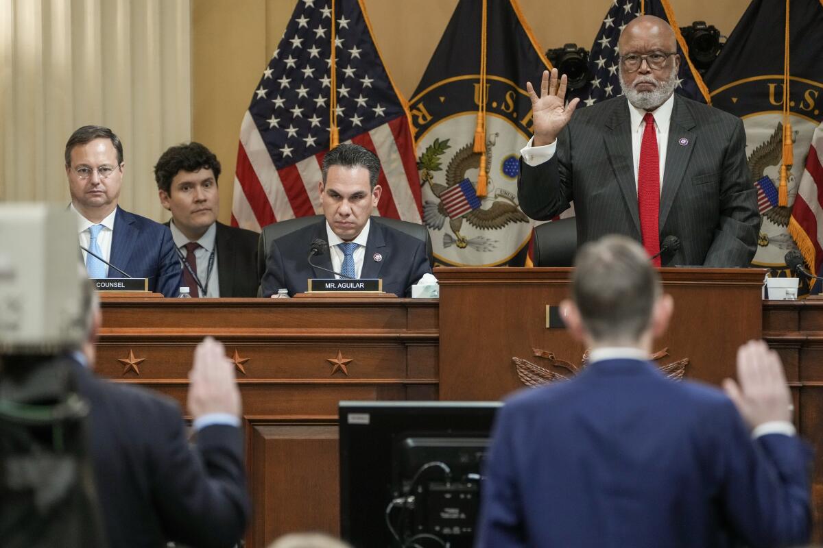 Chairman Bennie Thompson stands holding up his right hand as he swears in a witness