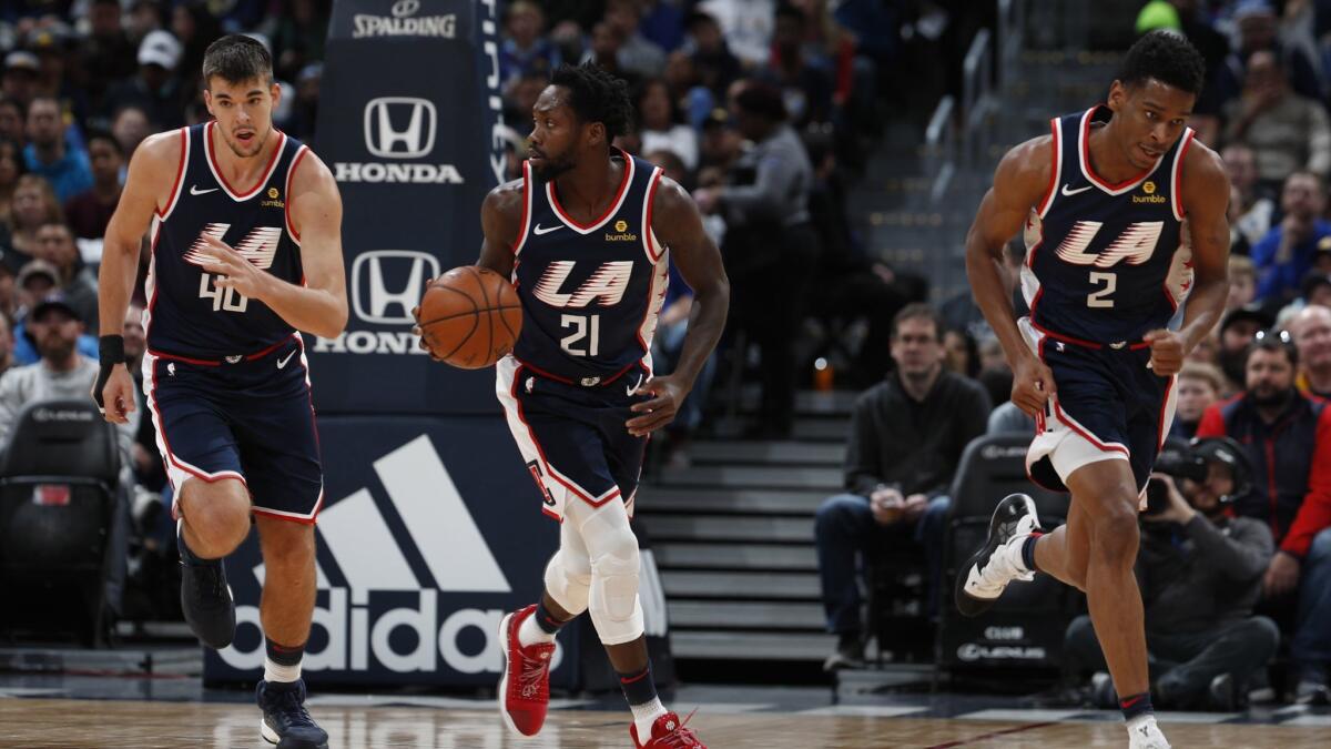 From left, Clippers center Ivica Zubac (40), guards Patrick Beverley (21) and Shai Gilgeous-Alexander (2) in the first half of a game on Feb. 24, 2019, in Denver.