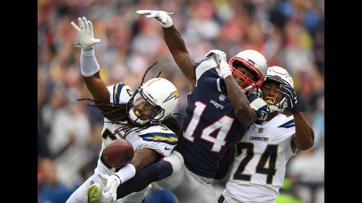 Chargers free safety Tre Boston, left, and cornerback Trevor Williams, right, break up a reception attempt by New England Patriots wide receiver Brandin Cooks during the first half.