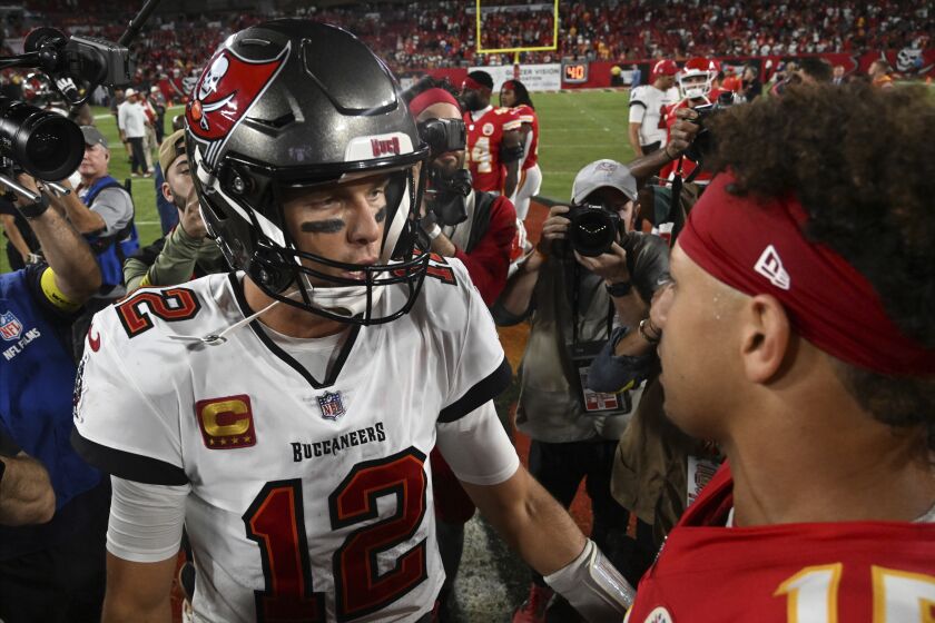 Tampa Bay Buccaneers quarterback Tom Brady (12) and Kansas City Chiefs quarterback Patrick Mahomes (15) greet each other after an NFL football game Sunday, Oct. 2, 2022, in Tampa, Fla. The Chiefs won 41-31. (AP Photo/Jason Behnken)