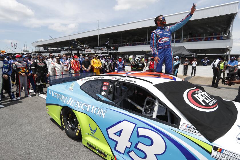 Driver Bubba Wallace takes a selfie with himself and other drivers that pushed his car to the front in the pits of the Talladega Superspeedway prior to the start of the NASCAR Cup Series auto race at the Talladega Superspeedway in Talladega Ala., Monday June 22, 2020. In an extraordinary act of solidarity with NASCAR’s only Black driver, dozens of drivers pushed the car belonging to Bubba Wallace to the front of the field before Monday’s race as FBI agents nearby tried to find out who left a noose in his garage stall over the weekend. (AP Photo/John Bazemore)