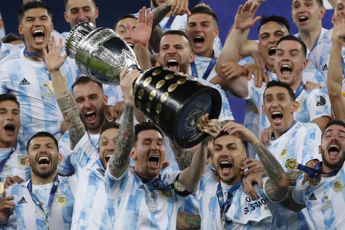 FILE - Argentina's Lionel Messi celebrates with the tro 