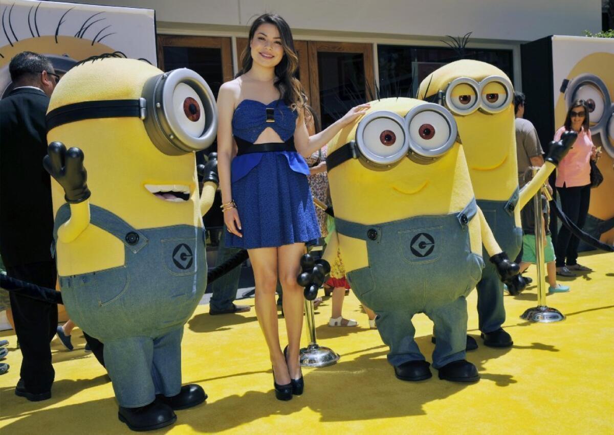 Miranda Cosgrove poses with minion characters at the premiere of "Despicable Me 2."