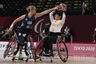 FILE - Britain's Amy Conroy (10) and China's Lin Suiling (9) battle for the ball during women's wheelchair basketball quarterfinal game at the Tokyo 2020 Paralympic Games, Tuesday, Aug. 31, 2021, in Tokyo, Japan. (AP Photo/Kiichiro Sato, File)