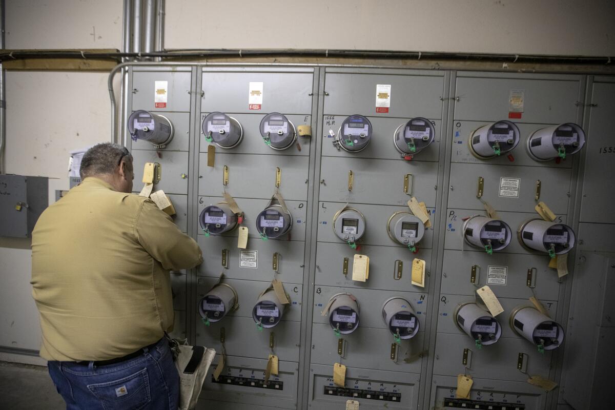 A Los Angeles Department of Water and Power worker shuts off electricity to an illegal marijuana dispensary