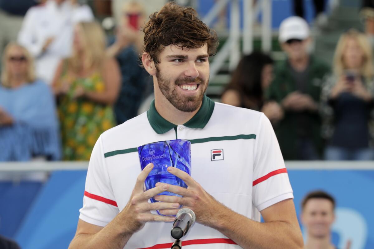 Reilly Opelka holds the trophy after winning the Delray Beach (Fla.) Open title match Feb. 23, 2020.