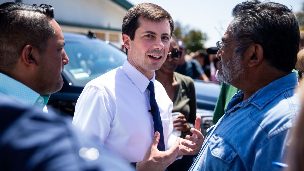Democratic presidential candidate Pete Buttigieg speaks with Humberto M. Gomez after an event in Fresno.