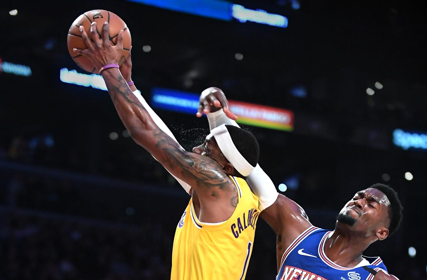 Lakers guard Kentavious Caldwell-Pope is hit in the head by Knicks forward Bobby Portis while driving to the basket during the second quarter of a game Jan. 7 at Staples Center.