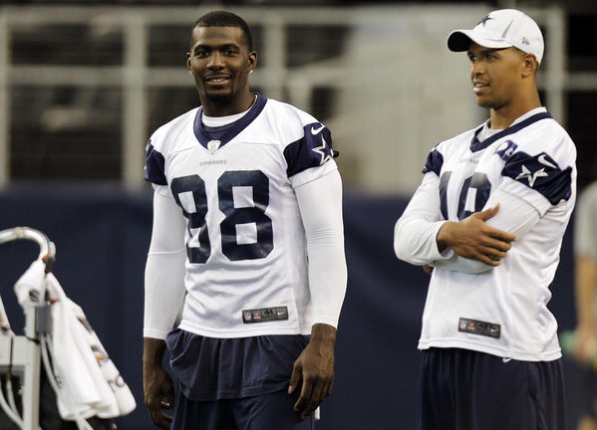 Dallas Cowboys wide receiver Dez Bryant, left, talks with teammate Miles Austin during practice.