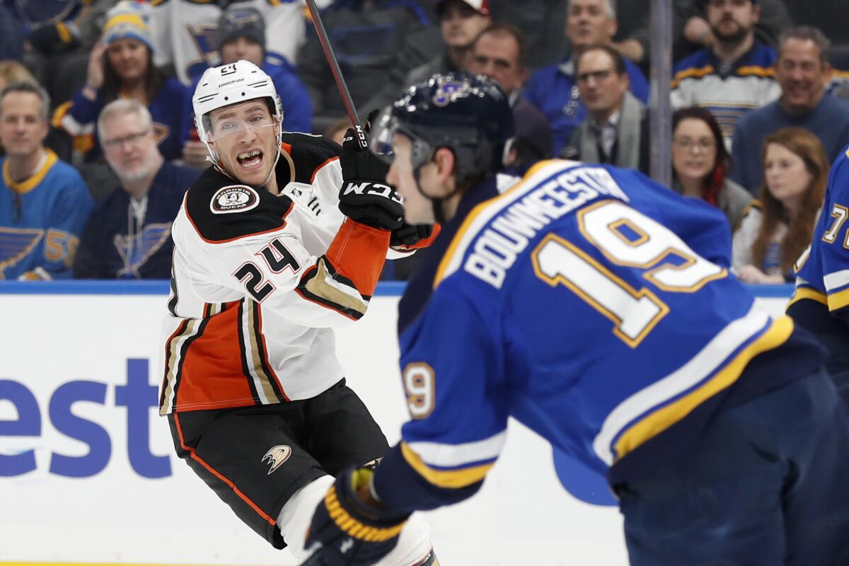 St. Louis Blues' Jay Bouwmeester (19) handles the puck as Ducks' Carter Rowney (24) defends during the first period on Monday in St. Louis.