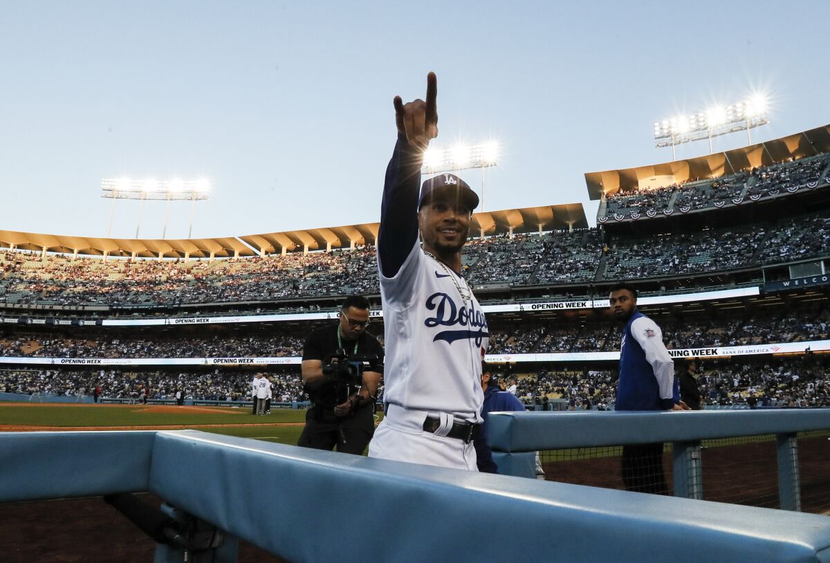 Dodgers right fielder Mookie Betts (50) points to the stands before the game against the Cincinnati Reds