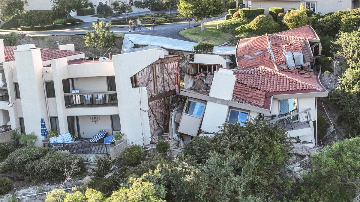 Townhomes severely damaged by a landslide sink below street level in Rolling Hills Estates on July 10, 2023.