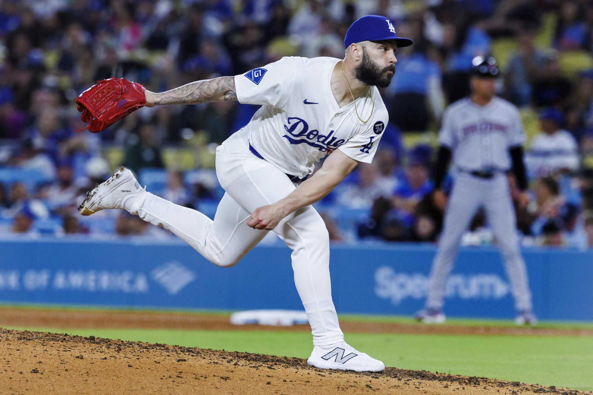 Dodgers pitcher Tanner Scott exhales while throwing the ball from the mound against the Arizona Diamondbacks