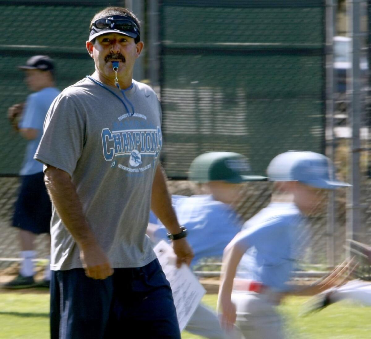Crescenta Valley High baseball Coach and Falcons Summer Baseball Camp creator Phil Torres whistles to signal campers transition to another skill station.