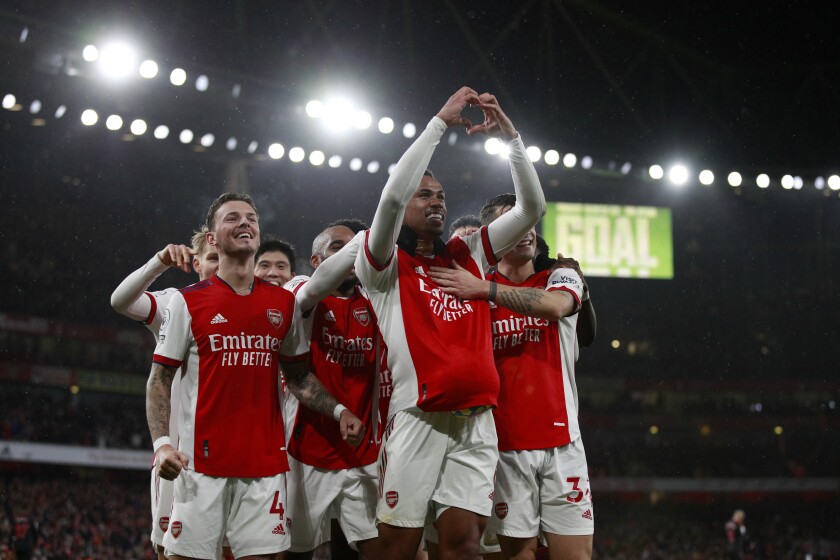 Arsenal's Gabriel Magalhaes, second right, gestures as he celebrates with teammates after scoring the third goal during the English Premier League soccer match between Arsenal and Southampton at Emirates stadium in London, Saturday, Dec. 11, 2021. (AP Photo/Ian Walton)