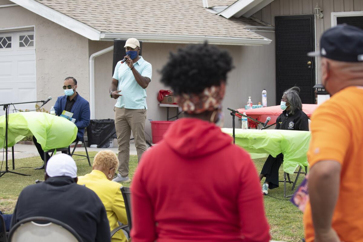 Compton mayoral candidates Cristian Reynaga and Emma Sharif at a Compton block club.