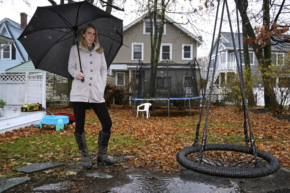 Claire Tillberg stands outside her family's home in a Boston suburb.