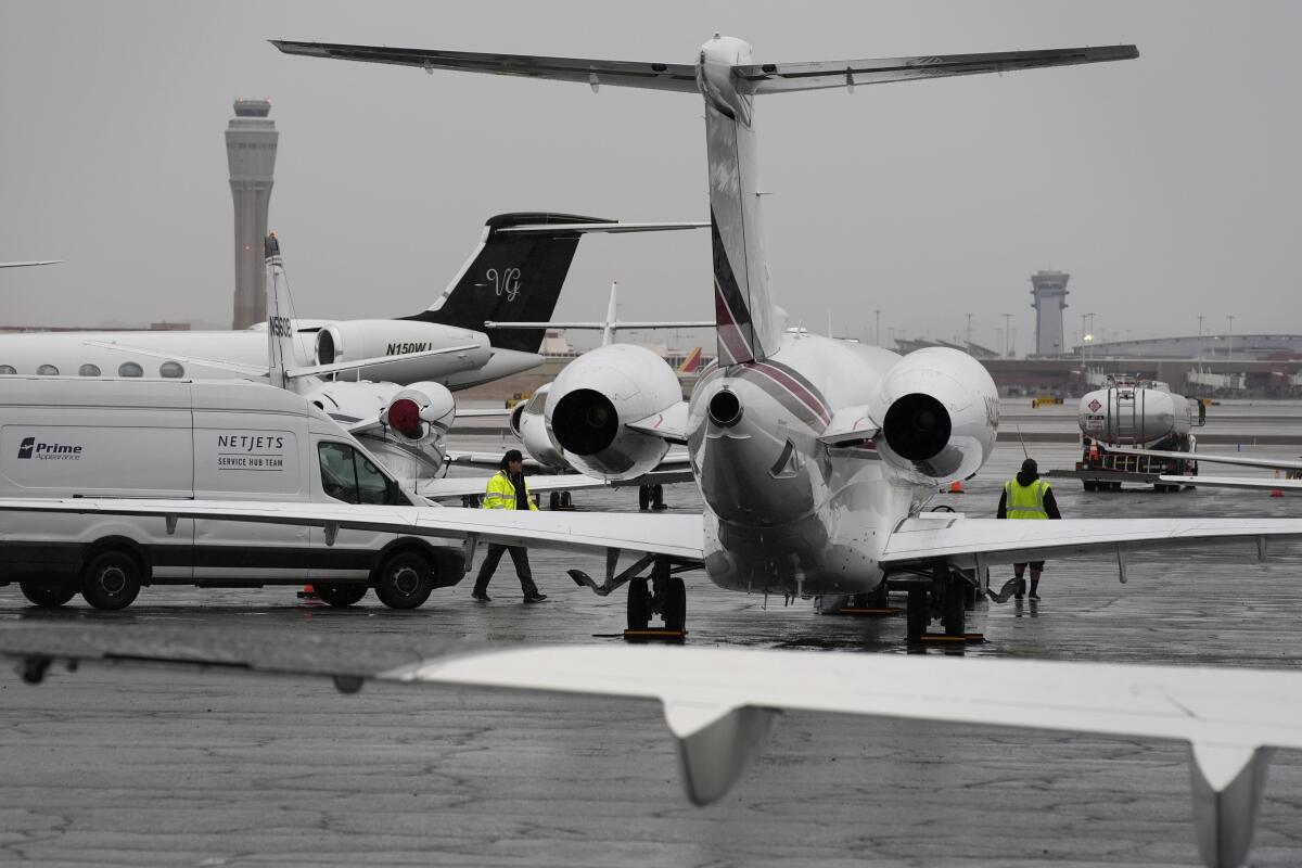 Planes are parked at a private jet terminal