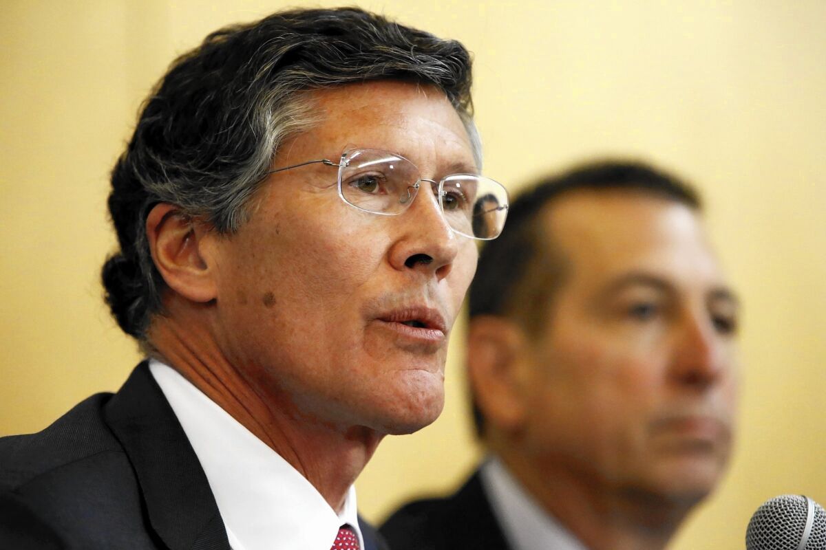CIT Group Chief Executive John Thain, left, and OneWest CEO Joseph Otting speak Thursday at a hearing in Los Angeles about the $3.4-billion takeover of OneWest Bank in Pasadena by New York commercial lender CIT Group.