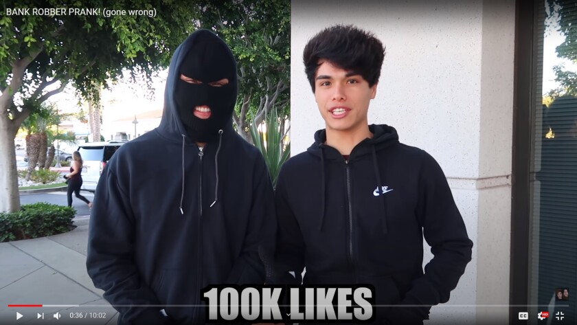 Alan and Alex Stokes appear in their "bank robbery" video, filmed in Irvine and posted in October.