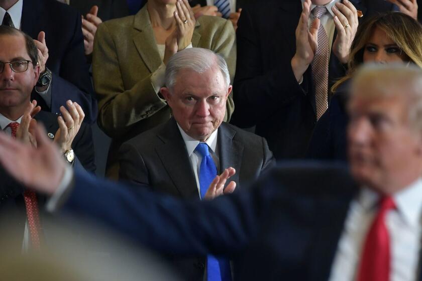 (FILES) In this file photo taken on March 19, 2018 Attorney General Jeff Sessions (C) and First Lady Melania Trump (R) applaud as US President Donald Trump speaks about combating the opioid crisis at Manchester Community College in Manchester, New Hampshire. - US Attorney General Jeff Sessions lashed back at increasing political pressure on him from President Donald Trump on August 23, 2018, declaring the Department of Justice would not bow to politics. (Photo by MANDEL NGAN / AFP)MANDEL NGAN/AFP/Getty Images ** OUTS - ELSENT, FPG, CM - OUTS * NM, PH, VA if sourced by CT, LA or MoD **