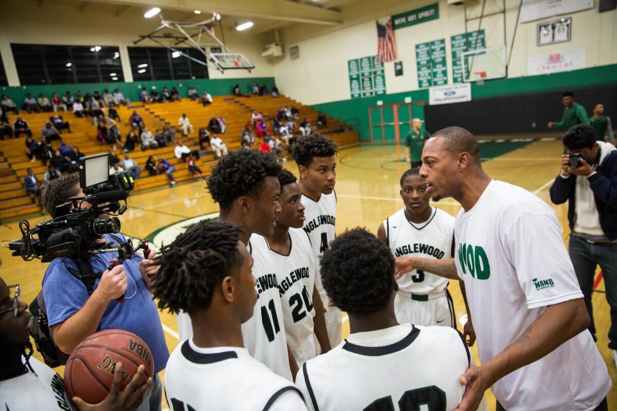 Clippers' Paul Pierce huddles with members of Inglewood's basketball team on Wednesday night.