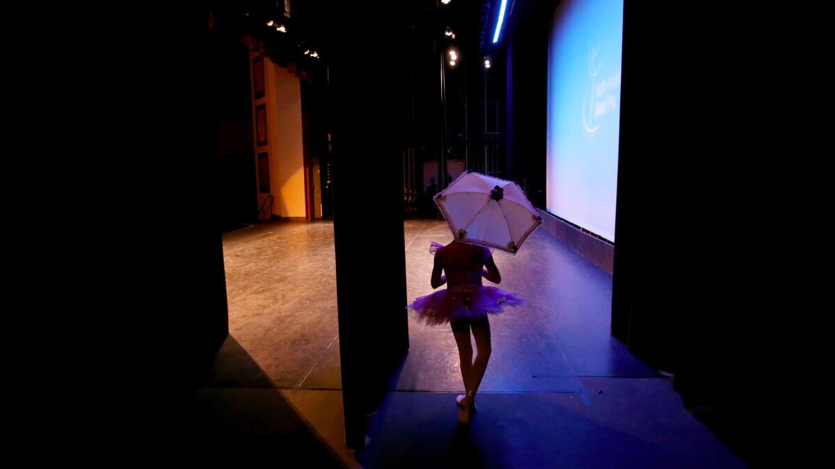 Sarah Reynolds prepares to take the stage for her audition in the Youth America Grand Prix regional semifinals at Huntington Beach High School. Hundreds turn out for the chance to receive scholarships to top dance schools.