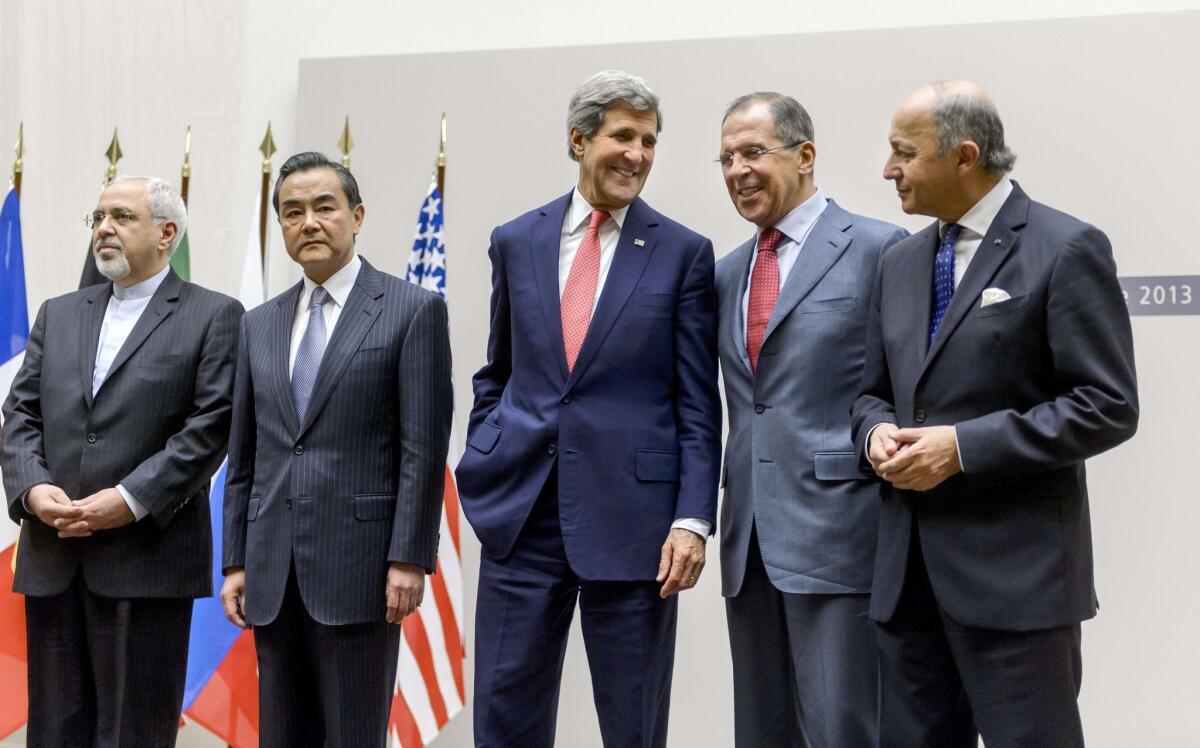 From left, Iranian Foreign Minister Mohammad Javad Zarif, Chinese Foreign Minister Wang Yi, U.S. Secretary of State John Kerry, Russian Foreign Minister Sergei Lavrov and French Foreign Minister Laurent Fabius react during a statement in Geneva after world powers agreed to a landmark deal with Iran halting parts of its nuclear program.