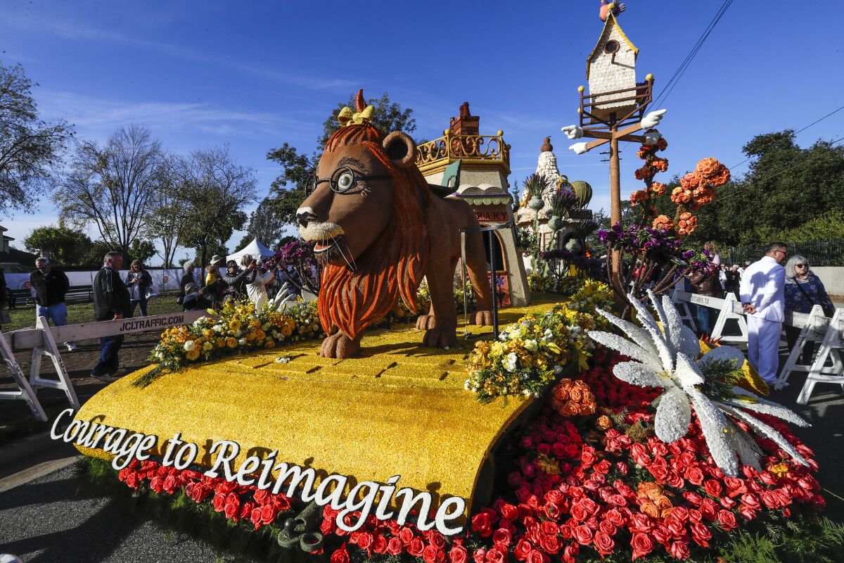 A Rose Parade float depicting a lion on a yellow road with the words Courage to Reimagine