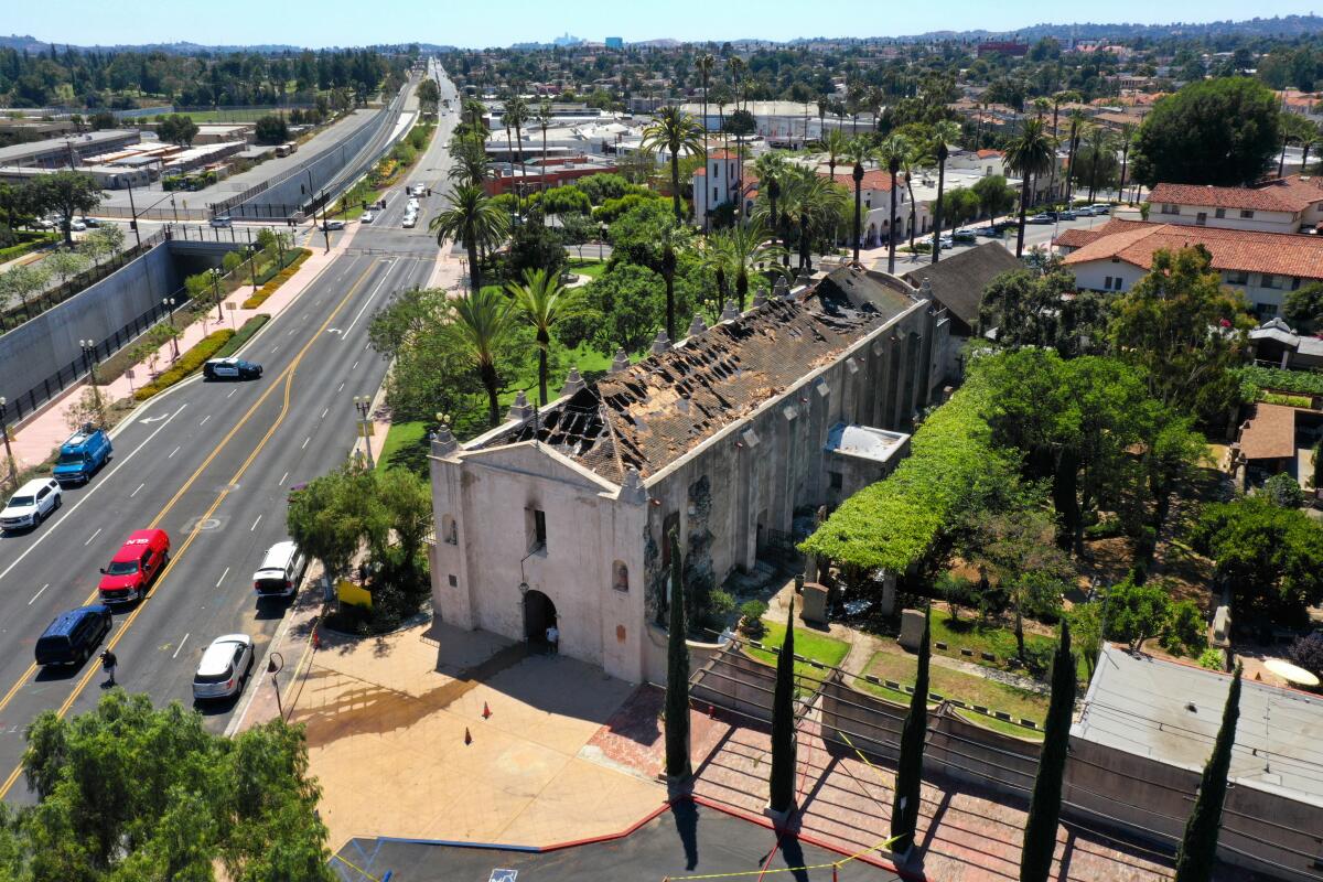 An aerial view of the fire-damaged roof of the San Gabriel Mission Church