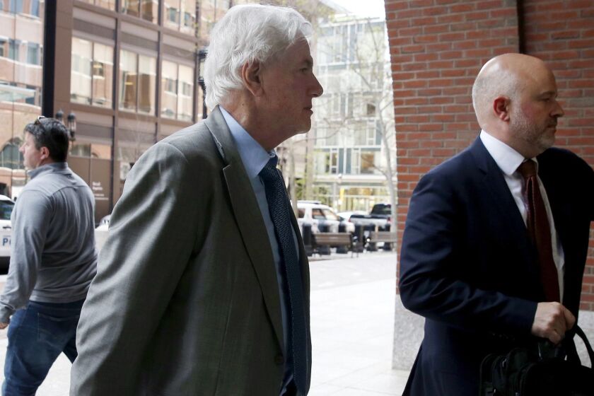 Gregory Abbott, center, arrives at federal court Wednesday, May 22, 2019, in Boston, where he is scheduled to plead guilty to charges in a nationwide college admissions bribery scandal. (AP Photo/Michael Dwyer)