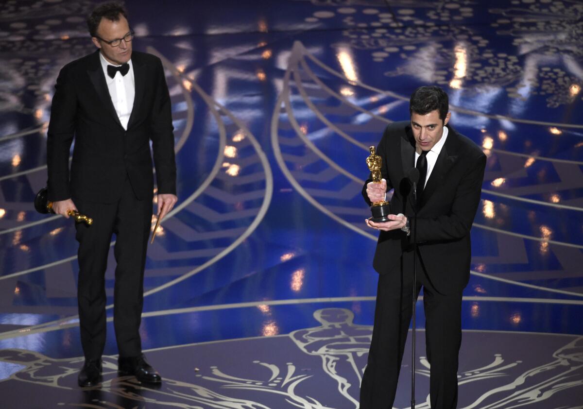 Tom McCarthy, left, and Josh Singer accept the Oscar for original screenplay for “Spotlight.”