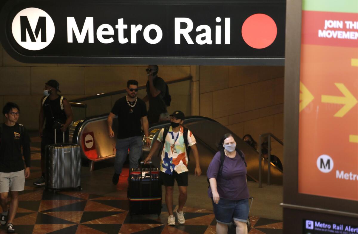 Travelers exit a Metro Rail line in Los Angeles.