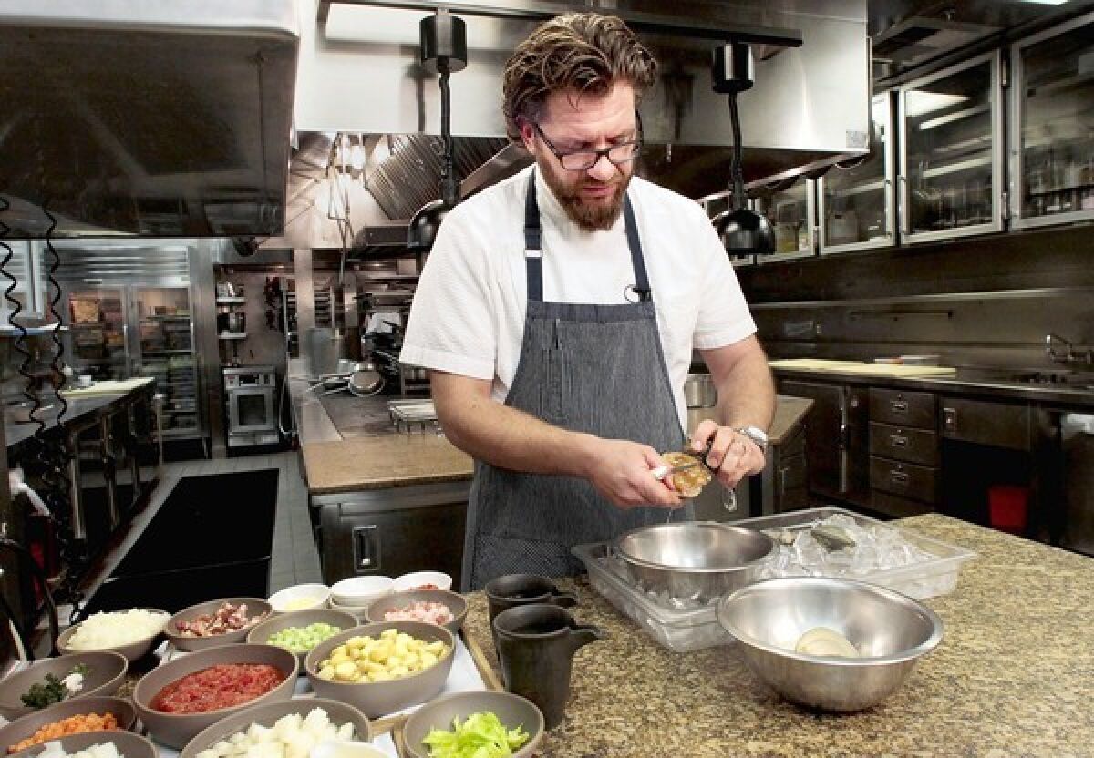 Chef Michael Cimarusti shucks clams at Providence restaurant.