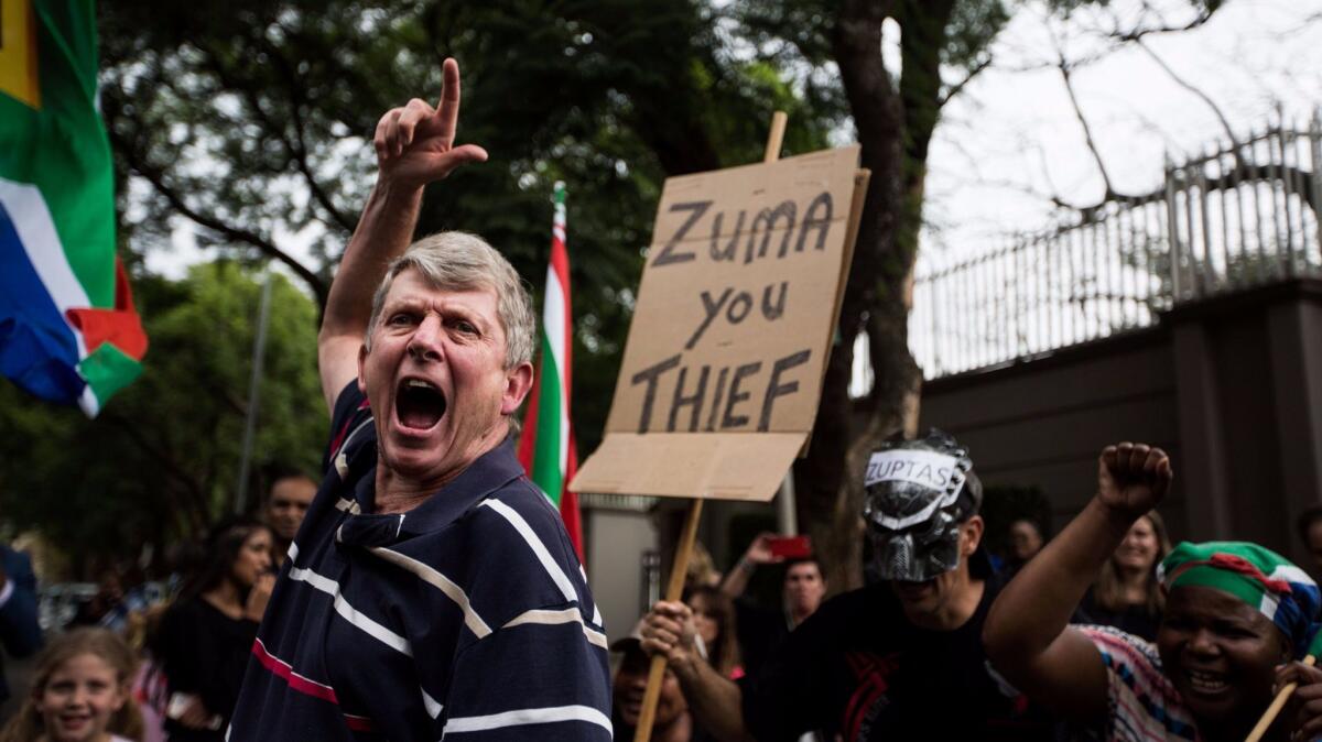 Protesters gather outside the Gupta family compound in Johannesburg, South Africa.