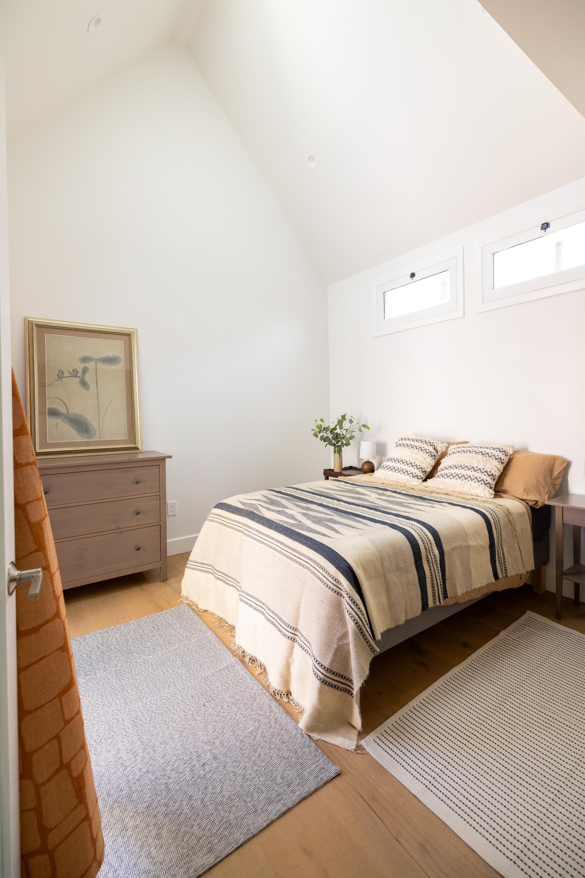 A bedroom with vaulted ceilings 