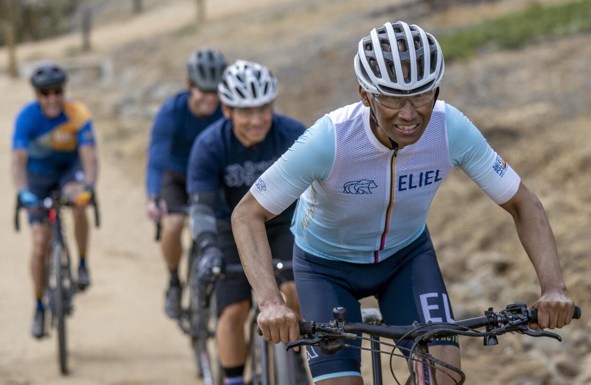 Robert Duran rides on a recreation trail in Encinitas with friends after weekly chemo