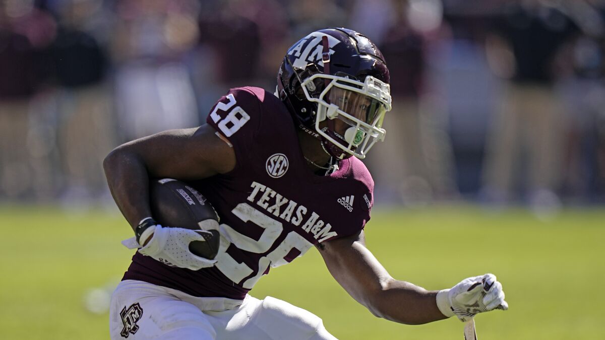 Texas A&M running back Isaiah Spiller rushes with the ball.