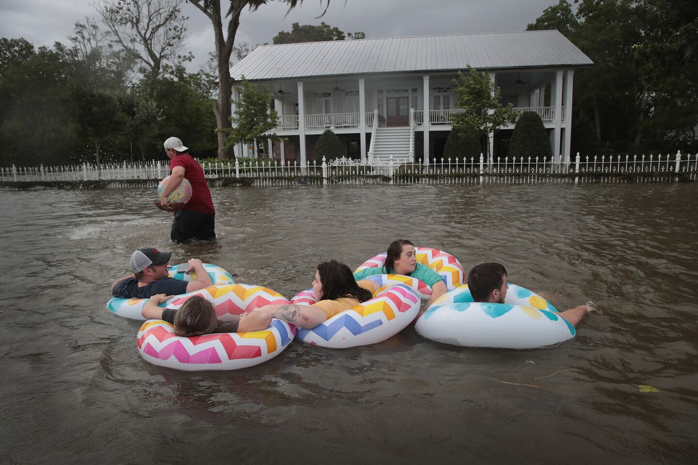 People float down Lakeshore Drive near Lake Pontchartrain after the Mandeville area flooded in the wake of Hurricane Barry.
