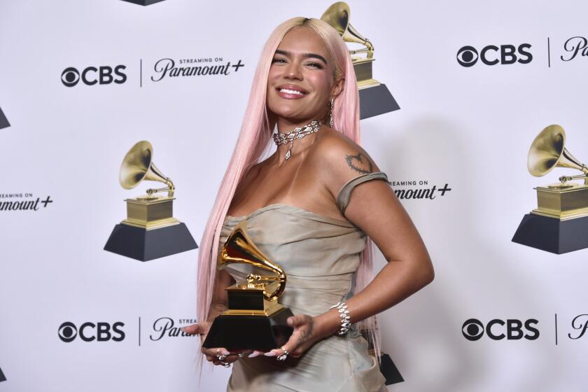FILE - Karol G poses in the press room with the award for best musica urbana album for "Manana Sera Bonito" during the 66th annual Grammy Awards on Sunday, Feb. 4, 2024, in Los Angeles. The 2024 Latin Grammys will return to Miami — where the show first started 25 years ago, and where the organization is headquartered. (Photo by Richard Shotwell/Invision/AP, File)