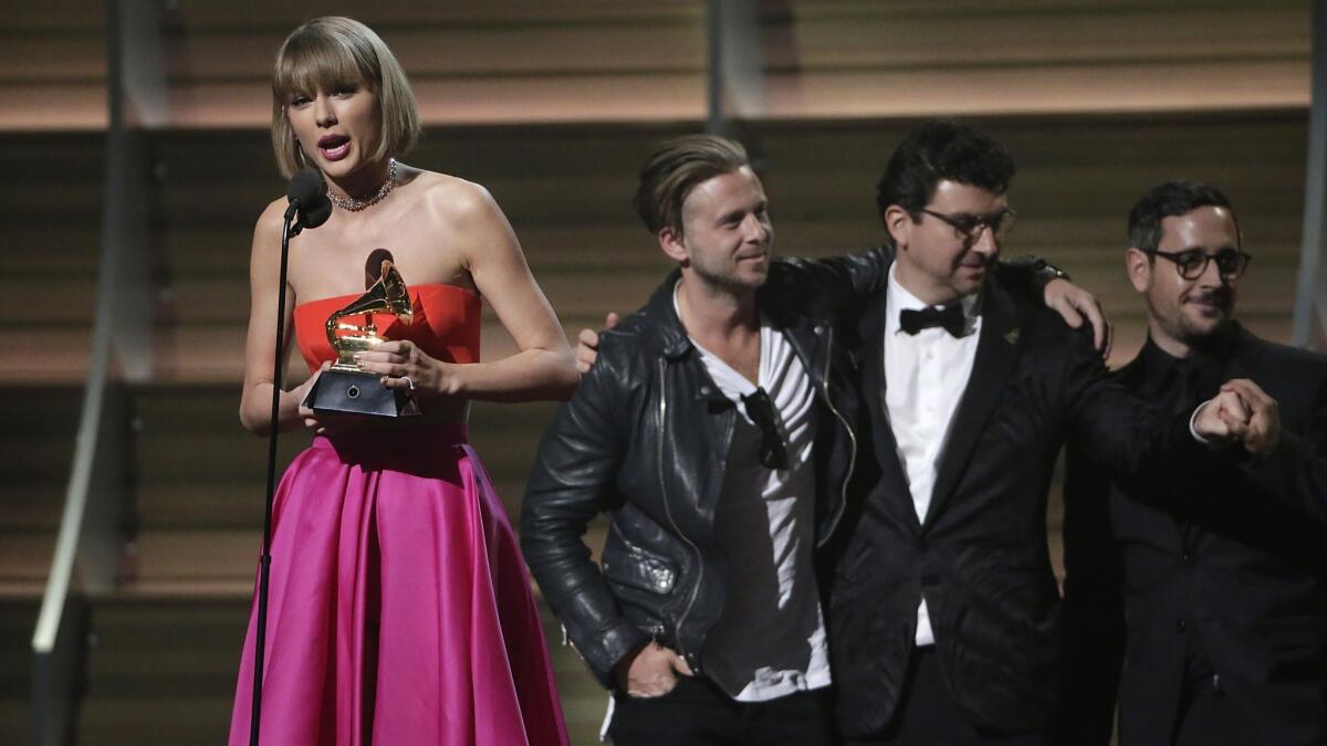 Taylor Swift accepts record of the year trophy at 58th Grammy Awards in 2016.