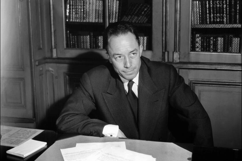 French writer Albert Camus is seen posing for a portrait in Paris.