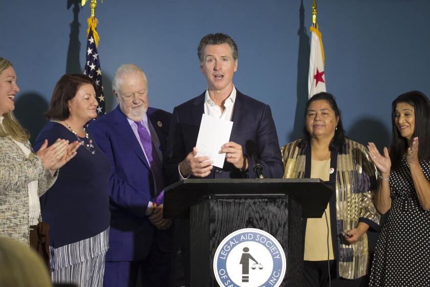 California Governor Gavin Newson came to San Diego on Wednesday, October 9, 2019 to sign Senate Bill 113 which provides a funding source for legal aid for renters and homeowners. With Newson who is holding up the bill after signing it is, L-r, Allison Snow, legal director for Legal Aid Society of San Diego, Senator Toni Atkins, Greg Knoll, Executive director of the Legal Aid Society of San Diego, Newson, Martha Rojas, a Legal Aid client who was helped by the society to keep her house, and Joanne Michaels, a client with Legal Aid.