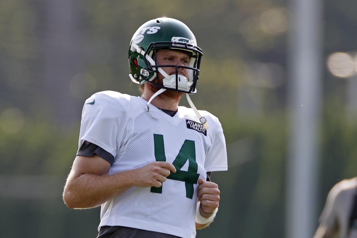 New York Jets quarterback Sam Darnold jogs on the practice field.