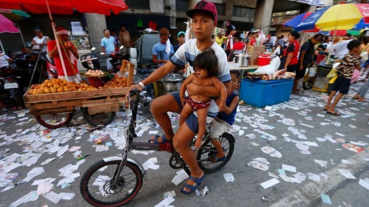 Election campaign materials litter a street in Manila as midterm elections drew to a close.