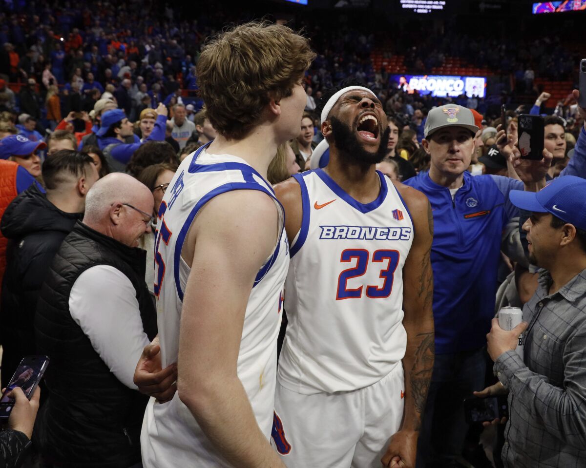 Boise State's Naje Smith (23) and Lukas Milner celebrate their win over San Diego State 