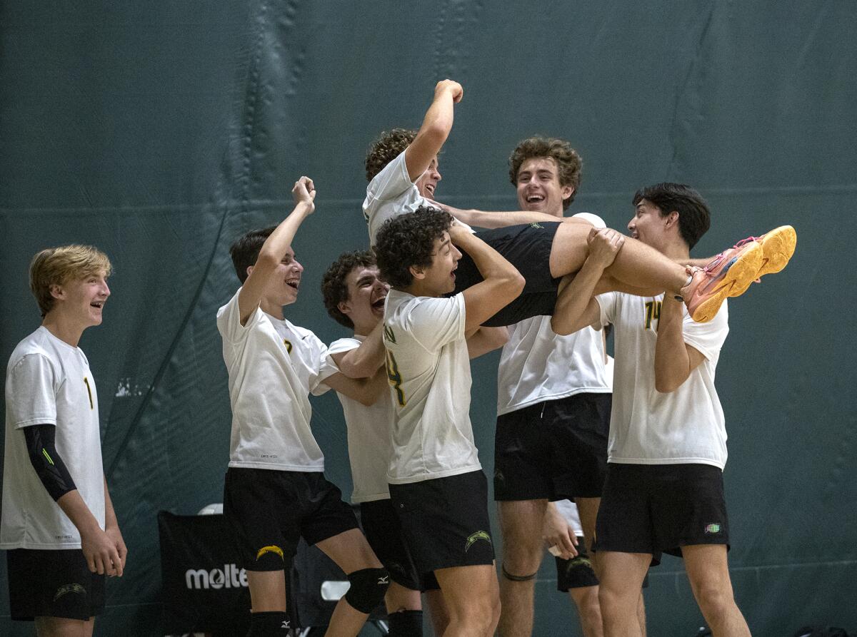 Edison's bench hoists Tyler Amelotte up in celebration during a Wave League match on Thursday.