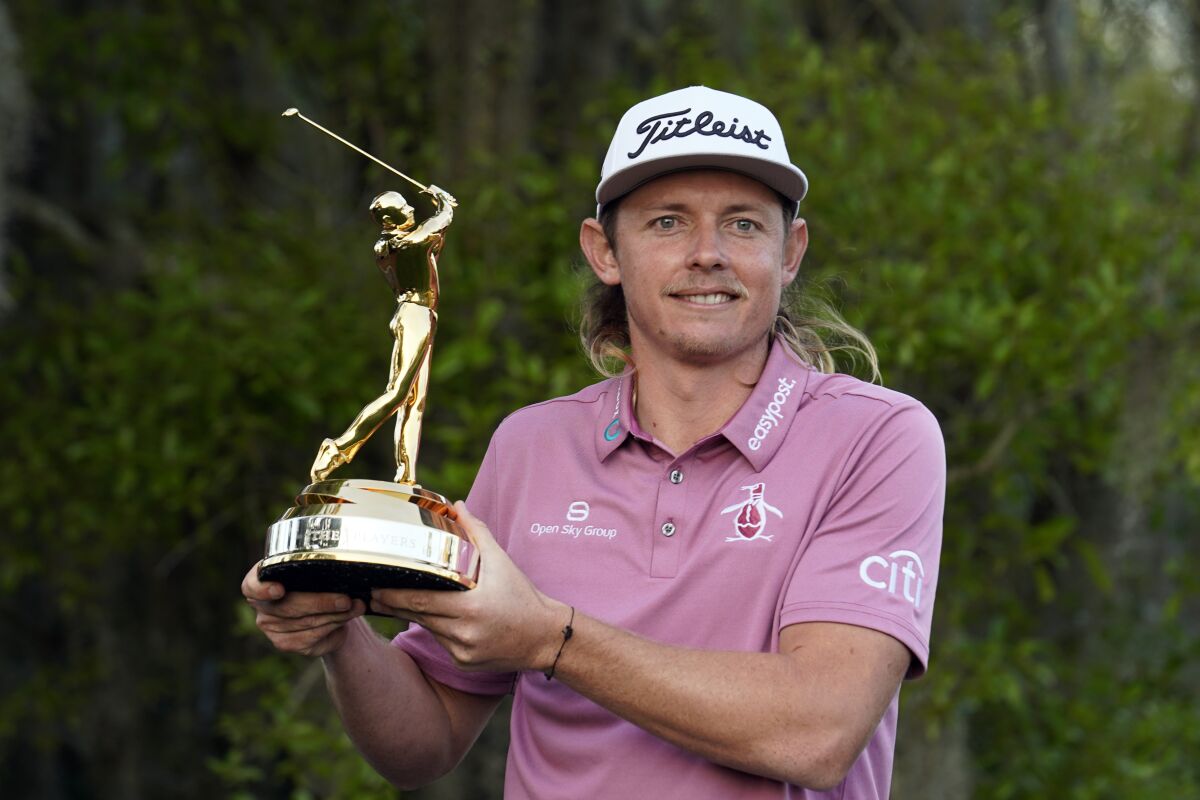 Cameron Smith, of Australia, holds the trophy after winning The Players Championship golf tournament Monday, March 14, 2022, in Ponte Vedra Beach, Fla. (AP Photo/Gerald Herbert)