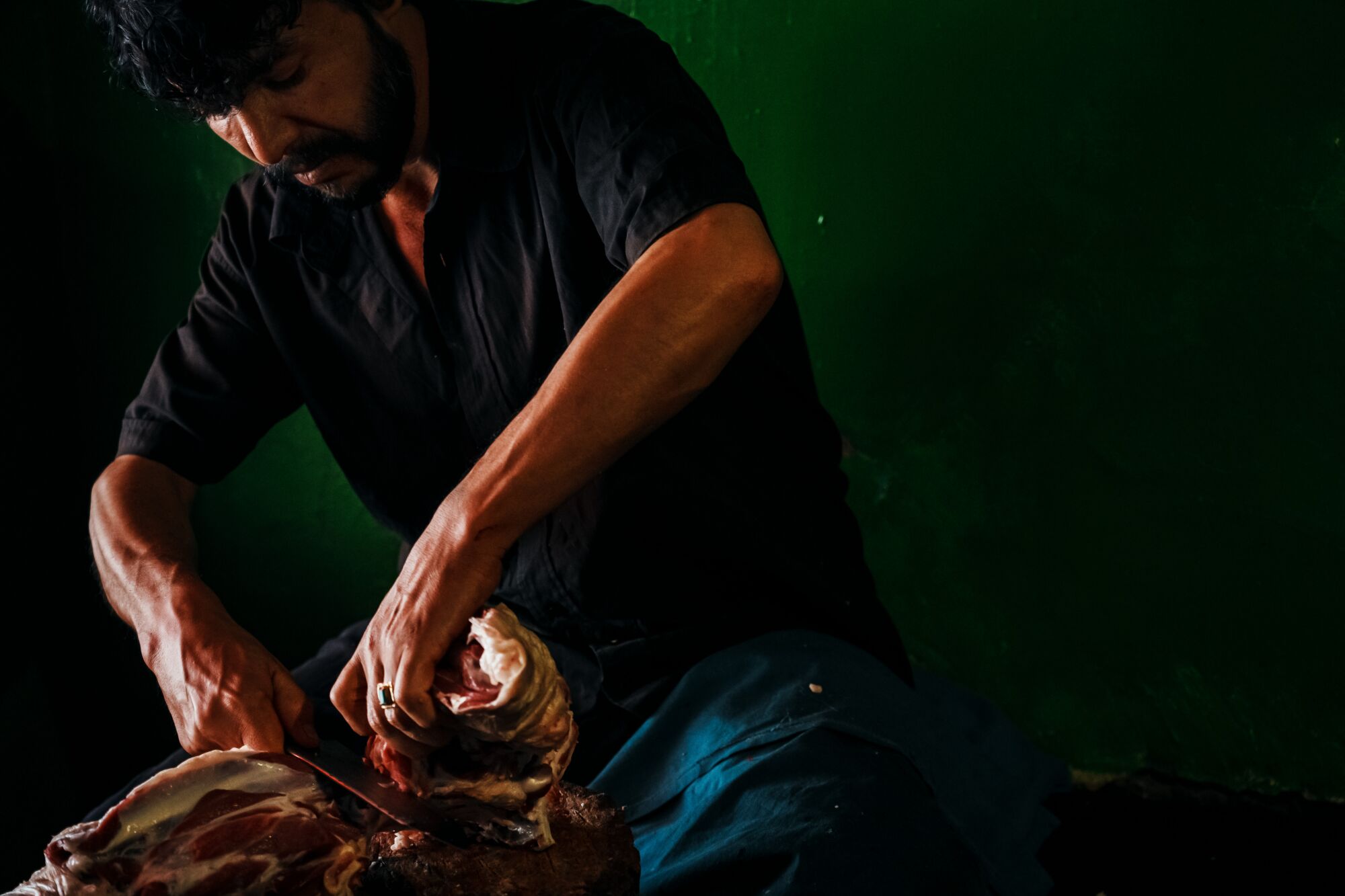 Man slicing up lamb meat